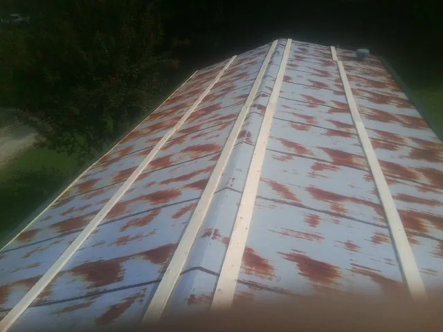 Rusted metal roof panels with new wood purlins before replacement — Storm Damage Roof Repair in Bridgeport by Roofing Brothers
